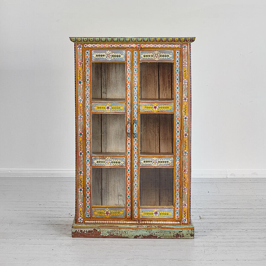 Decorative wooden cabinet with intricate patterns on a white background
