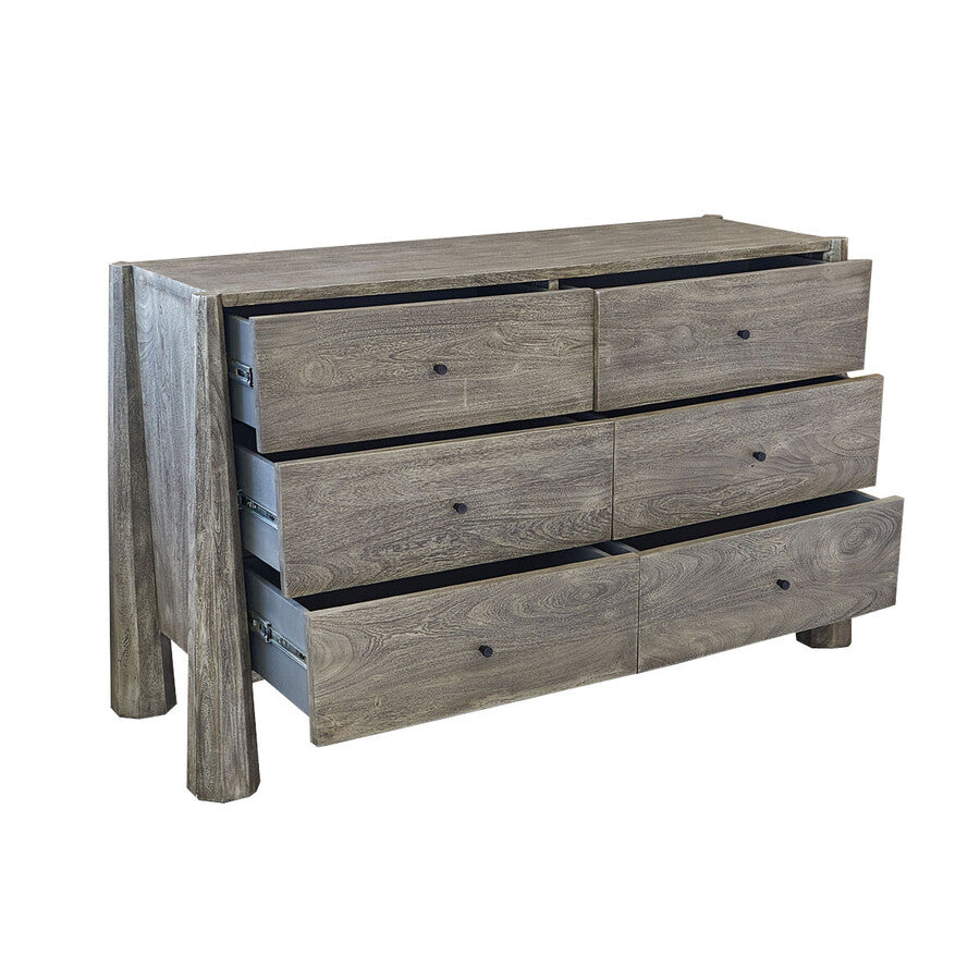 Wooden dresser with four drawers on a white background