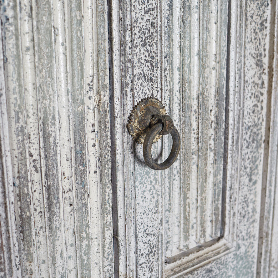 Metal door handle on a textured metal door