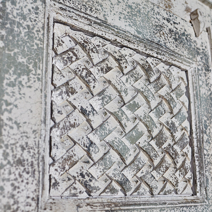 Decorative stone pattern with a lattice design on a textured surface
