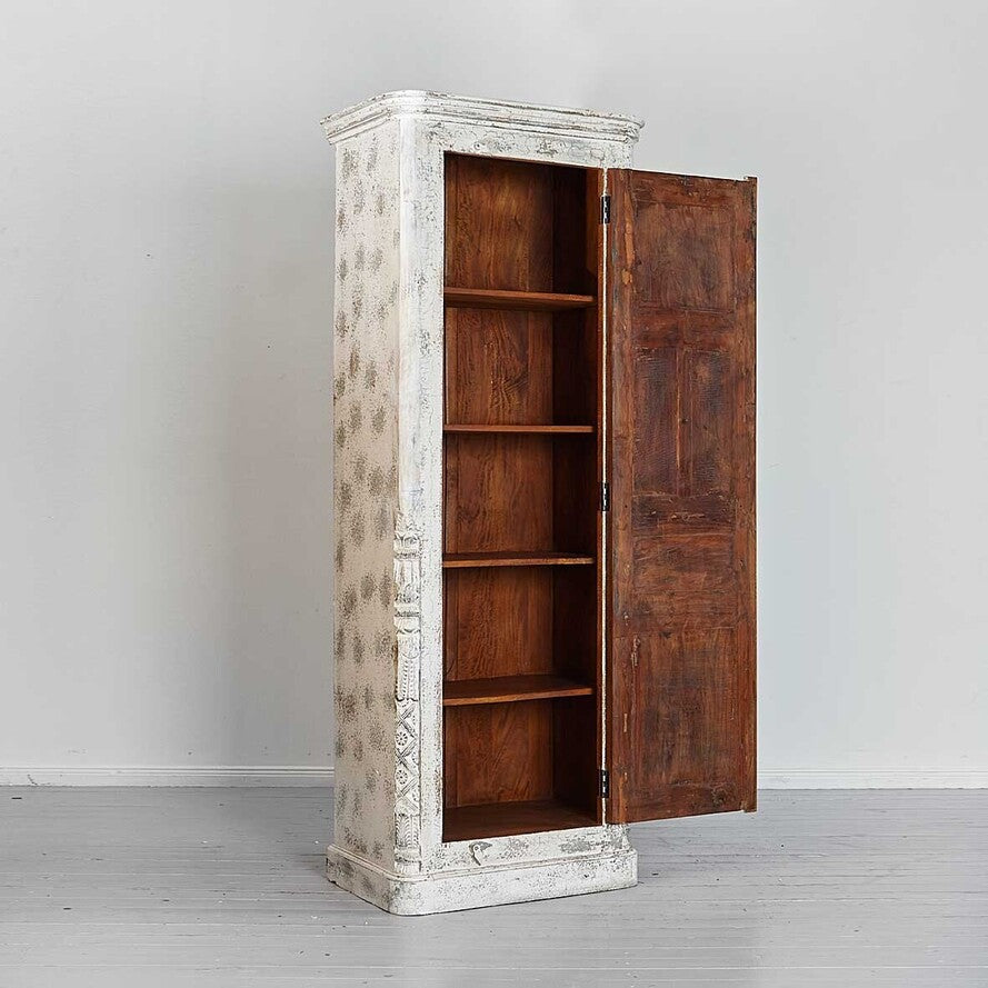 Wooden cabinet with distressed white finish and open wooden doors on a gray floor.