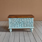 Hand‑carved mango wood storage trunk in distressed blue, 60 × 36 × 36 cm.

