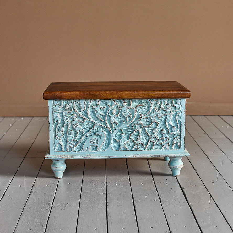 Hand‑carved mango wood storage trunk in distressed blue, 60 × 36 × 36 cm.


