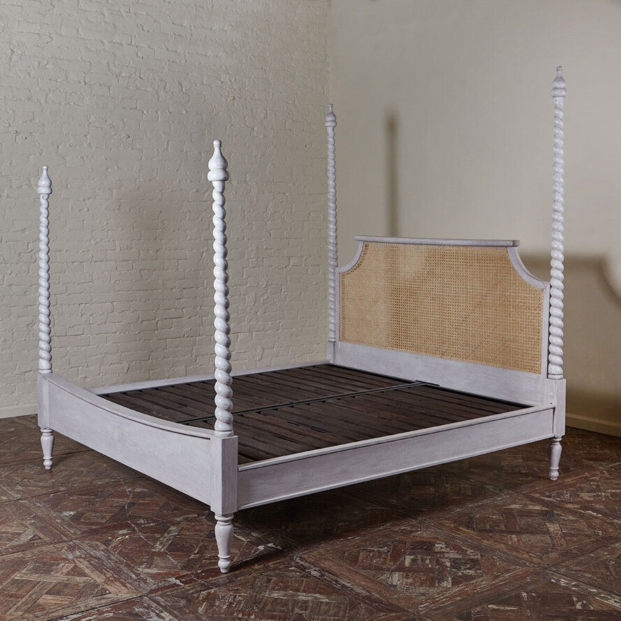 Perspective view of a handcrafted Jodhpur spiral-turned bed frame in distressed white.