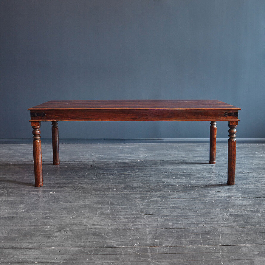 Wooden table against a gray wall on a gray floor