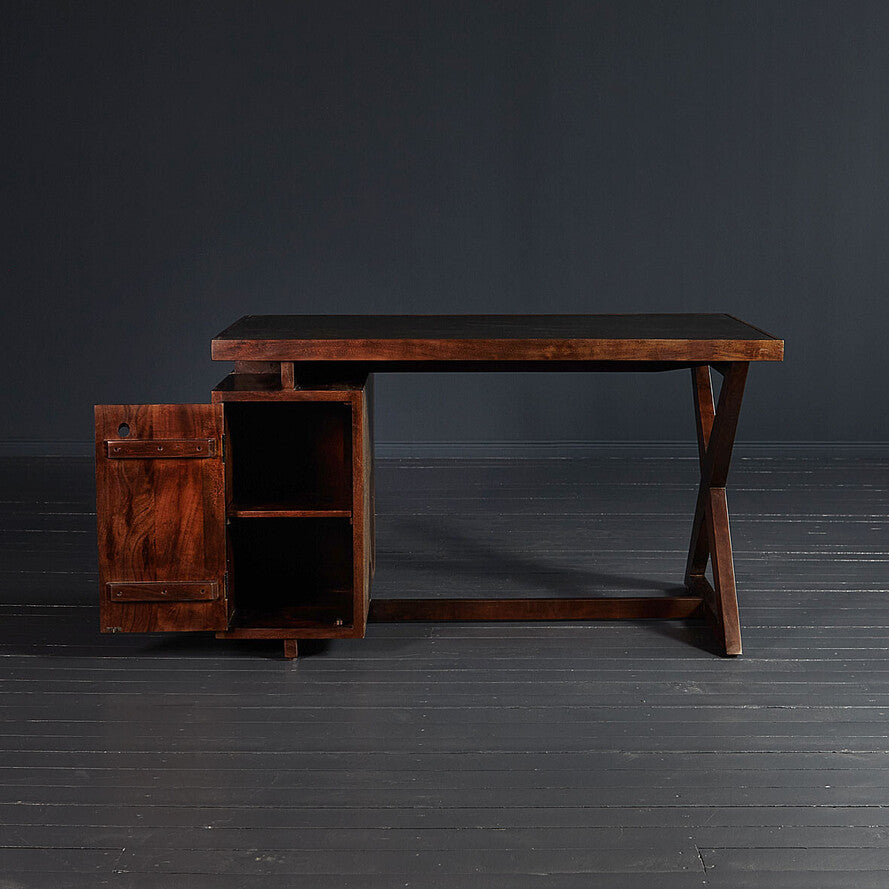Wooden desk with a cabinet on a dark floor and background