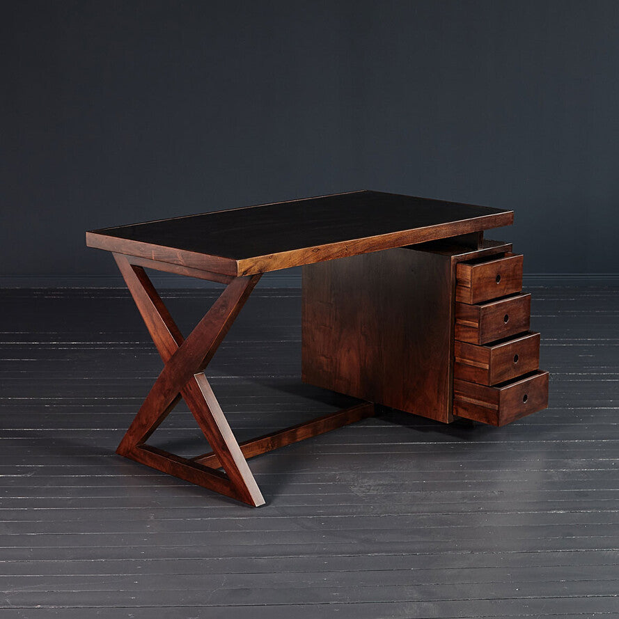 Wooden desk with drawers on a dark background