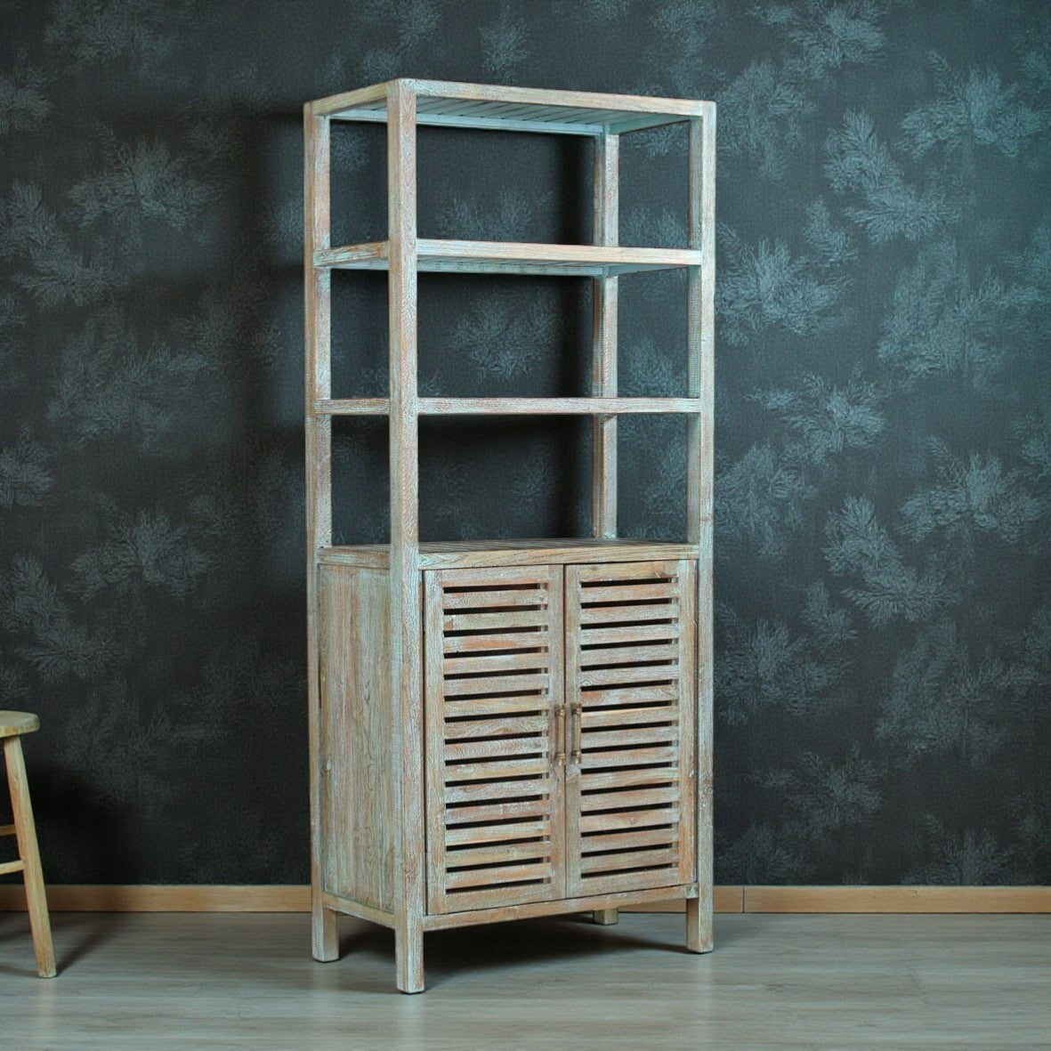 Wooden shelf with a door against a dark textured wall
