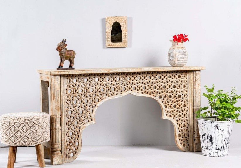 "Elegant wooden console table styled in a modern living room with decorative accents."
