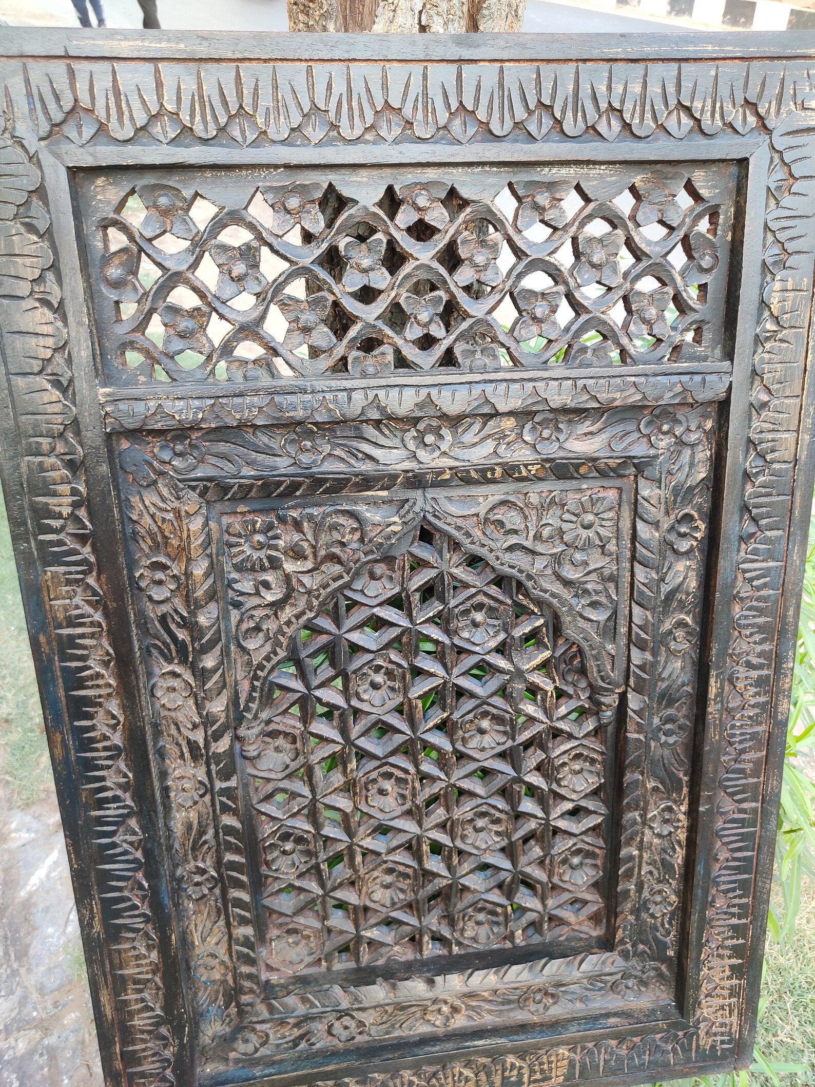 Decorative wooden panel with intricate carvings and patterns