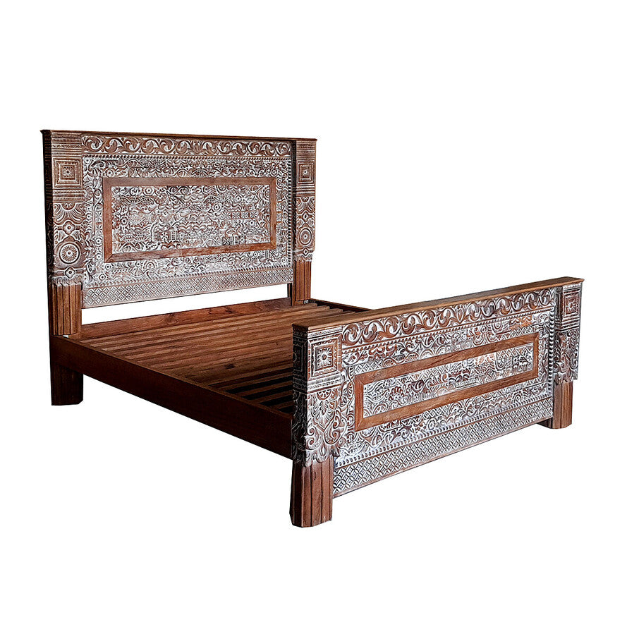 Decorative wooden bed with intricate carvings on a white background