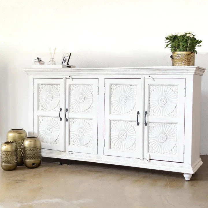 hand carved sideboard, mango wood sideboard, all white sideboard, white sideboard, floral carved sideboard, openwork sideboard, 4 door sideboard, 4 drawer sideboard, buffet sideboard, indian carved furniture, storage sideboard, dining room buffet, living room sideboard, entryway sideboard, statement sideboard, large sideboard, handmade sideboard, artisan made sideboard, premium wood buffet, quality wood furniture, durable sideboard, sturdy buffet, timeless sideboard, elegant buffet, grand sideboard, heirloo