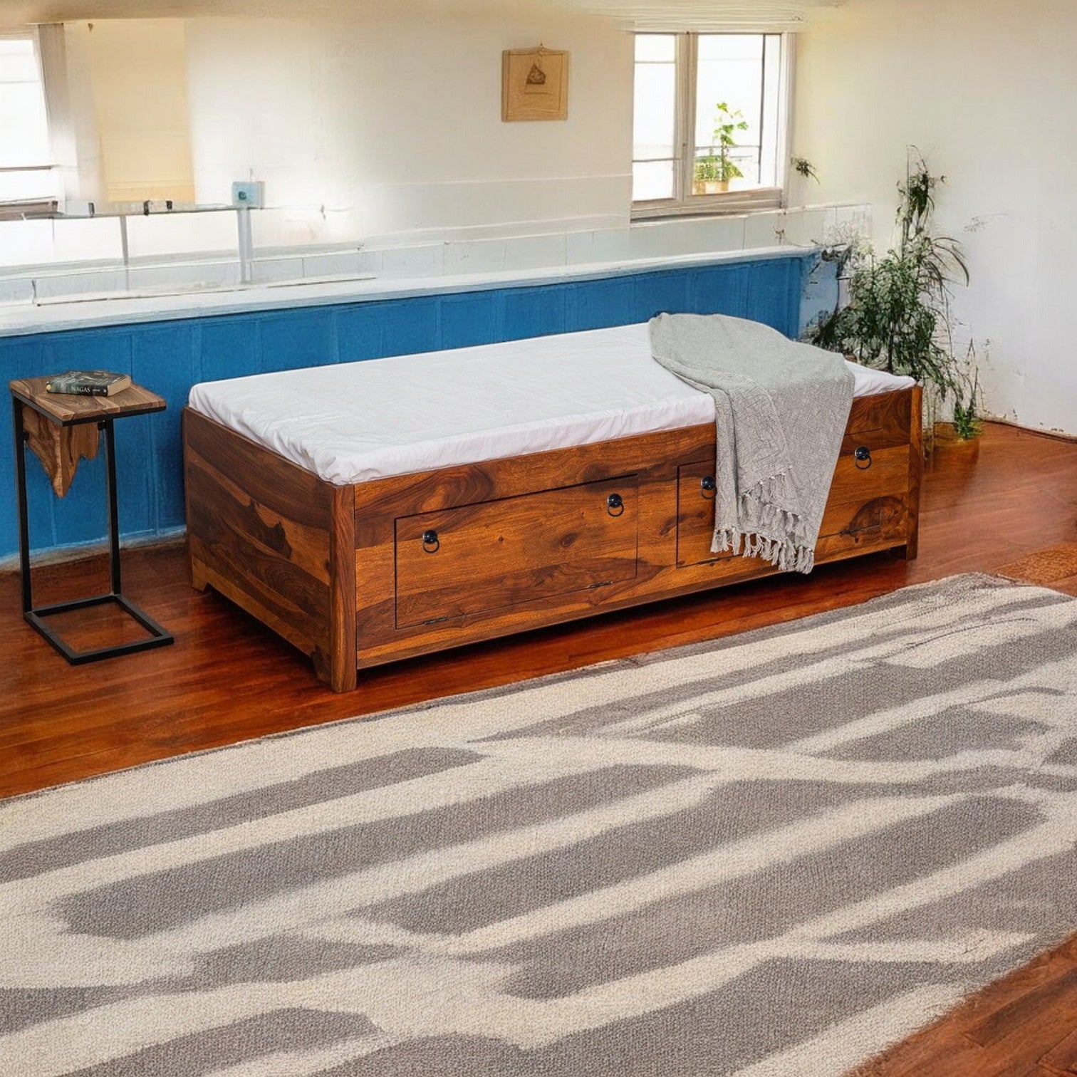 Luxurious divan bed with drawers in a well-lit modern room.
