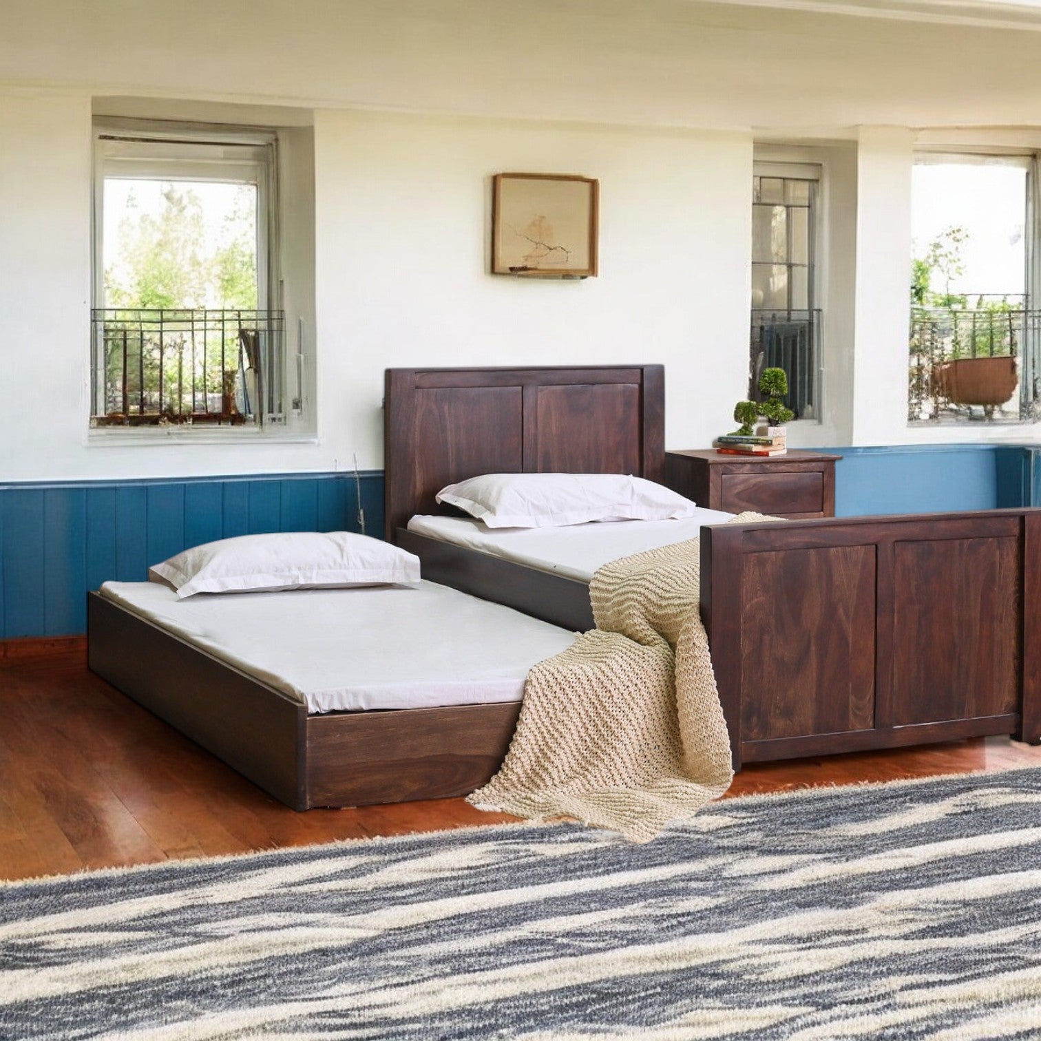 Trundle bed with sleek and modern design, perfect for saving space.
