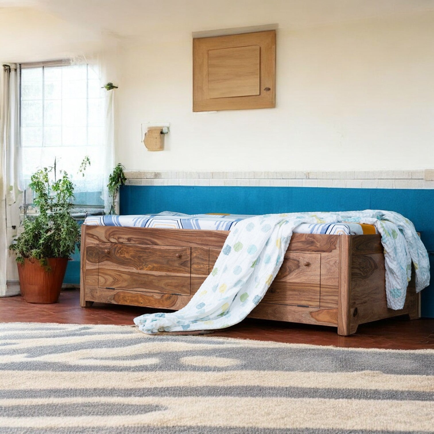 A compact single divan bed with storage in a cozy bedroom.
