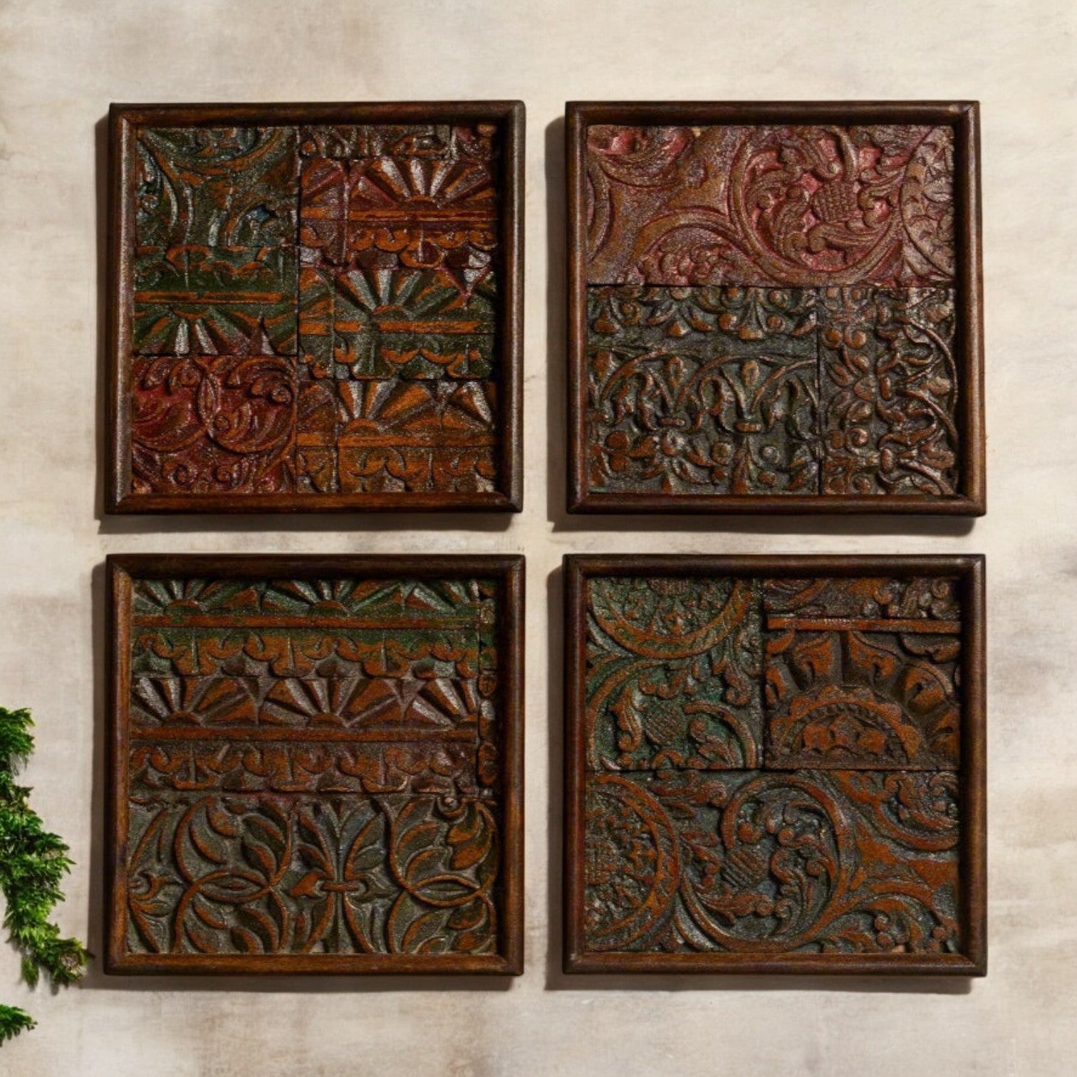 Set of 4 handcrafted carved wood wall panels arranged in a grid on a wall.
