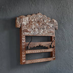 Decorative wooden wall shelf with intricate carvings on a dark gray wall.